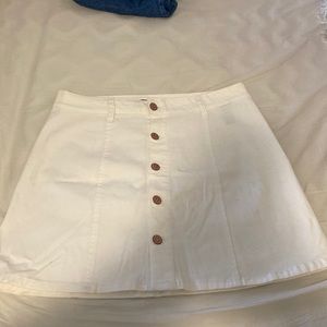 A white celebrity pink jean skirt with buttons